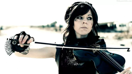 HD PC desktop wallpaper featuring Lindsey Stirling playing the violin, highlighting her dynamic music style against a blurred outdoor background.