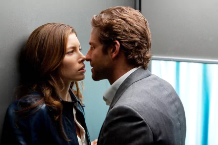 A dramatic scene from the movie The A-Team featuring Bradley Cooper and Jessica Biel, captured in vivid detail, showcasing their intense faces in close proximity.