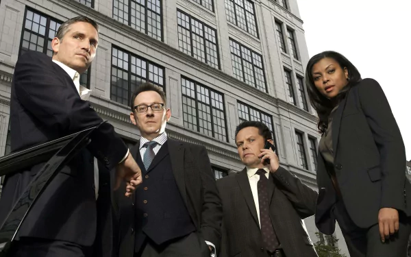 HD desktop wallpaper featuring Kevin Chapman, Taraji P. Henson, Jim Caviezel, and Michael Emerson from the TV show Person of Interest, standing in front of a city building.