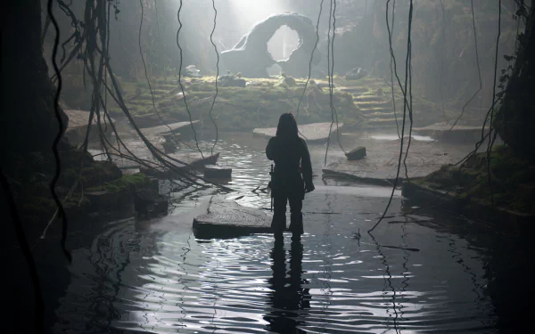 A 4K Ultra HD scene from Pirates of the Caribbean: On Stranger Tides showing a silhouetted figure standing in shallow water inside a cavern with hanging vines and a rock archway.