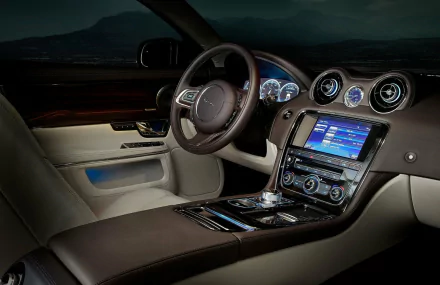 HD desktop wallpaper showcasing the luxury interior and dashboard of a Jaguar XJ vehicle, highlighting its sleek design and advanced technology features.