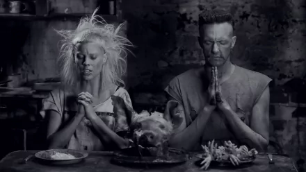 Black and white HD desktop wallpaper featuring members of Die Antwoord in a haunting, artistic scene with a pig's head and religious prayer poses.