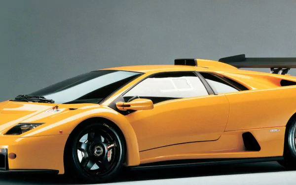 HD PC desktop wallpaper featuring a sleek yellow Lamborghini Diablo sports car against a neutral background.