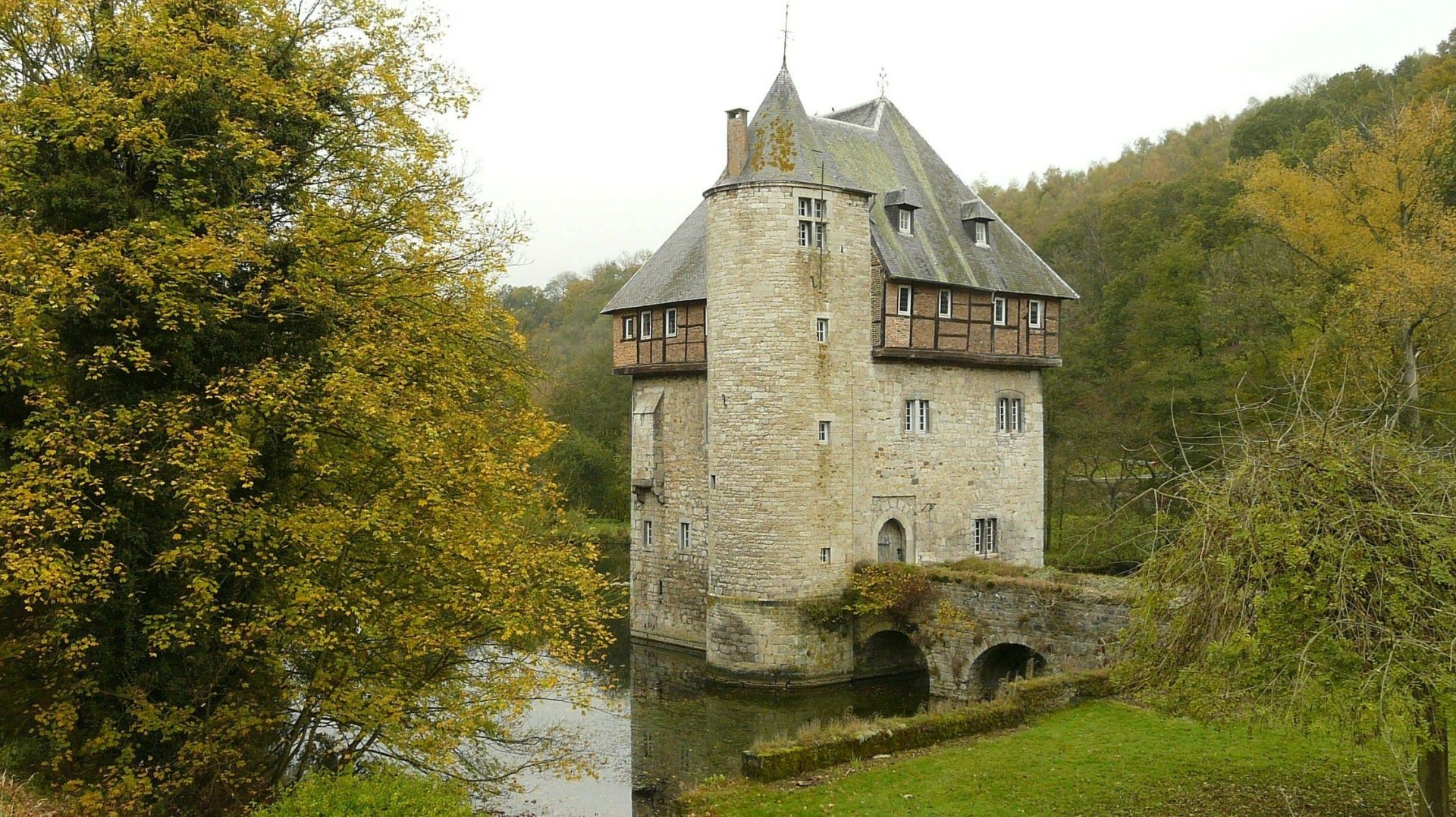 Historic Carondelet stone tower surrounded by greenery and water, captured in a man-made structure photo, featured as an HD PC desktop wallpaper and background.
