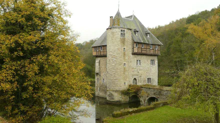 Historic Carondelet stone tower surrounded by greenery and water, captured in a man-made structure photo, featured as an HD PC desktop wallpaper and background.