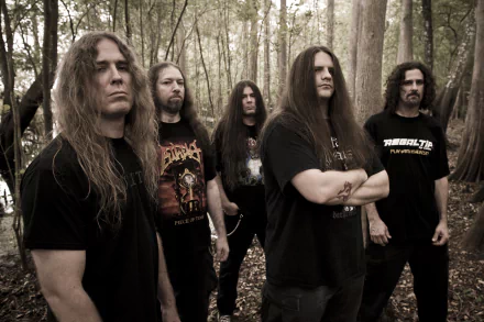 Five long-haired men in black metal shirts stand in a misty forest; moody desaturated photo, 2K Quad HD music desktop wallpaper.