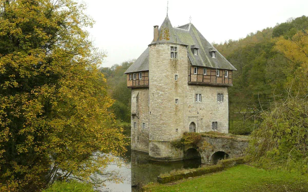 Historic Carondelet stone tower surrounded by greenery and water, captured in a man-made structure photo, featured as an HD PC desktop wallpaper and background.