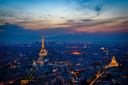 HD desktop wallpaper of the Eiffel Tower and Paris cityscape at sunset, showcasing man-made buildings under a colorful sky.