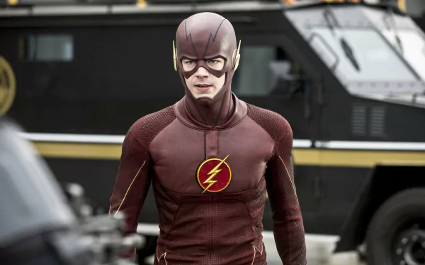 Barry Allen, portrayed by Grant Gustin, stands confidently in his iconic Flash suit. This HD desktop wallpaper from the TV show The Flash (2014) captures his dynamic presence.