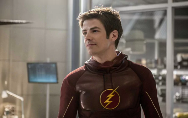 Barry Allen, portrayed by Grant Gustin, stands in his Flash suit in a scene from the TV show The Flash (2014), surrounded by a high-tech environment.