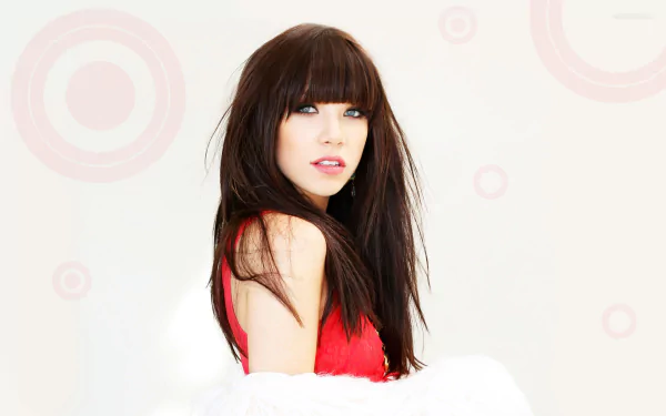 HD PC desktop wallpaper: music-themed portrait of a brunette pop artist in a red dress and white fur shrug against a pale background with soft circular motifs.