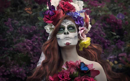 Artistic sugar skull portrait as a 2K Quad HD PC desktop wallpaper and background — woman with painted skull makeup, floral crown and butterflies amid deep purple blooms.