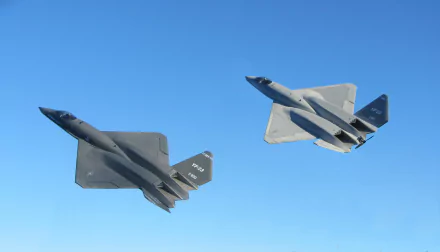 Two Northrop YF-23 stealth fighters banking in a clear blue sky, military 4K Ultra HD PC desktop wallpaper/background.
