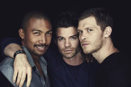 A close-up of three male characters from the TV show The Originals, captured in a dramatic light, showcasing a mix of intensity and camaraderie, fitting as a 4K Ultra HD desktop wallpaper.