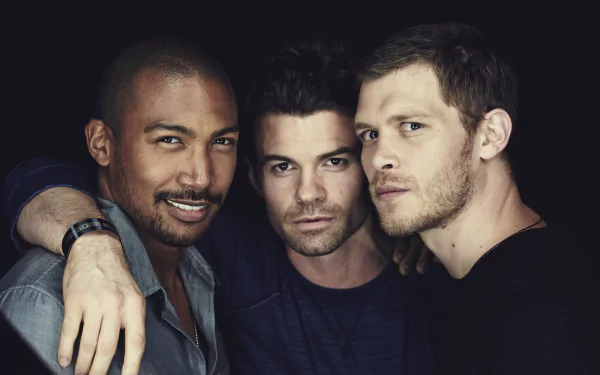 A close-up of three male characters from the TV show The Originals, captured in a dramatic light, showcasing a mix of intensity and camaraderie, fitting as a 4K Ultra HD desktop wallpaper.