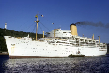 HD desktop wallpaper showing the ocean liner SS Arcadia, a large white ship docked by the coastline with a lighthouse in the background.