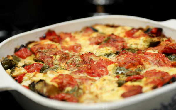 4K Ultra HD close-up of a tomato frittata meal, showcasing vibrant tomatoes and herbs in a baked dish, presented as a PC desktop wallpaper and background.