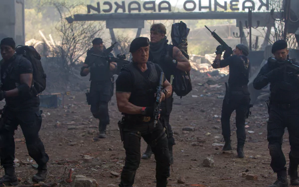 Action scene from The Expendables 3: armed mercenaries advance through a bombed-out urban street, rifles raised, dust and debris swirling in gritty 4K cinematic detail.