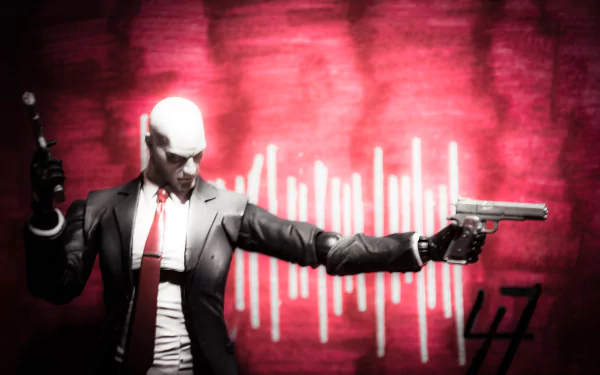 4K Ultra HD PC wallpaper featuring the Hitman character in a suit holding dual pistols against a vibrant red background with abstract light patterns.