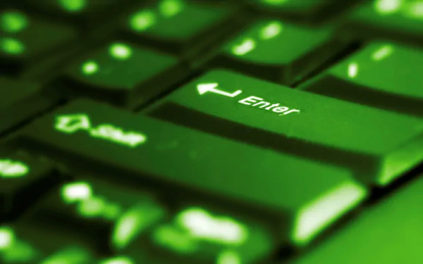 Close-up of a green backlit keyboard with the Enter key prominently displayed, showcasing technology in an HD PC desktop wallpaper and background.