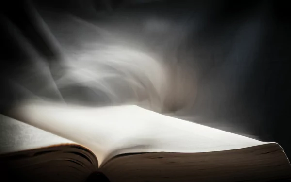 A close-up of an open book with ethereal light and smoke rising above, rendered in 4K Ultra HD for a striking PC desktop wallpaper background.