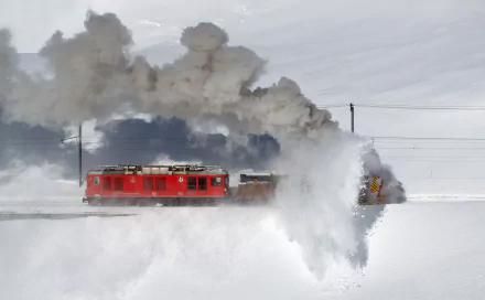 A RhB train vehicle powers through deep snow, creating a dramatic plume of white against a snowy landscape in this 4K Ultra HD desktop wallpaper.