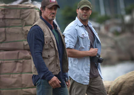 Jason Statham as Lee Christmas and Sylvester Stallone as Barney Ross in a scene from *The Expendables*. This image serves as a 4K Ultra HD desktop wallpaper.