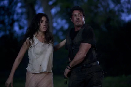 Sandra and Barney Ross, portrayed by Giselle Itié and Sylvester Stallone, face danger in this dramatic scene from the movie The Expendables, captured in stunning 4K Ultra HD.