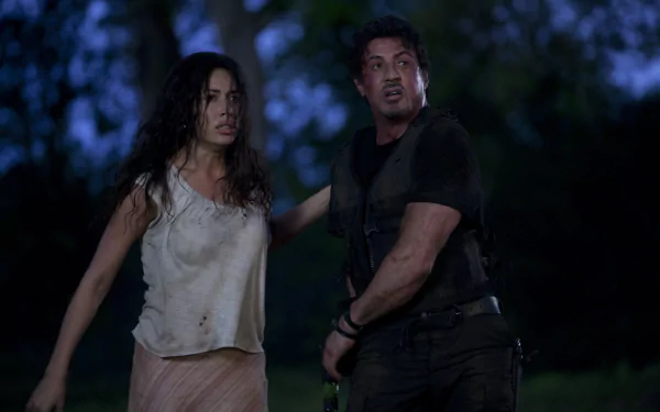 Sandra and Barney Ross, portrayed by Giselle Itié and Sylvester Stallone, face danger in this dramatic scene from the movie The Expendables, captured in stunning 4K Ultra HD.