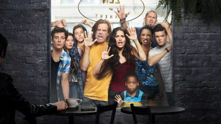 A vibrant HD wallpaper featuring the cast of the TV show Shameless, showcasing their expressive faces and dynamic energy against an urban backdrop.