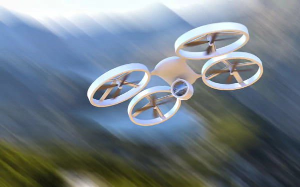 A sleek drone soars against a blurred mountain backdrop, showcasing a modern design. This 4K Ultra HD image serves as an eye-catching desktop wallpaper.