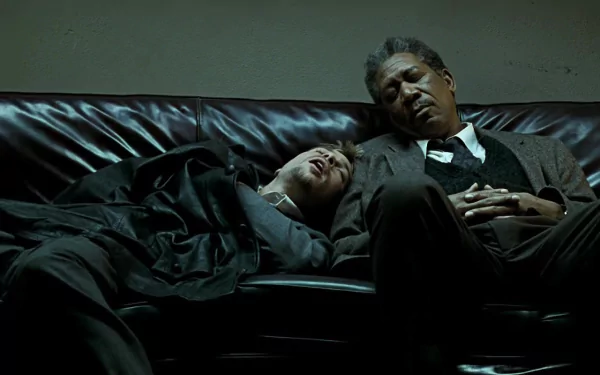 HD desktop wallpaper featuring Brad Pitt and Morgan Freeman resting on a couch, a scene from the movie Se7en.