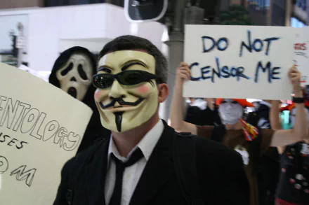 A HD desktop wallpaper showing people in masks, including an anonymous mask, holding signs about censorship. Tags: technology, anonymous.