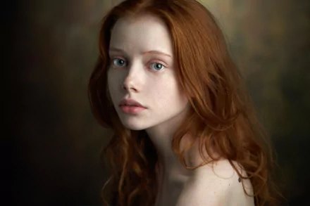 HD desktop wallpaper of a redhead woman model with long hair, showcasing a close-up of her face against a soft, blurred background.