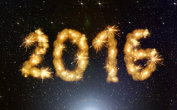 New Year holiday 2016 2K Quad HD PC desktop wallpaper and background: golden sparkler 2016 glowing against a starry black sky.