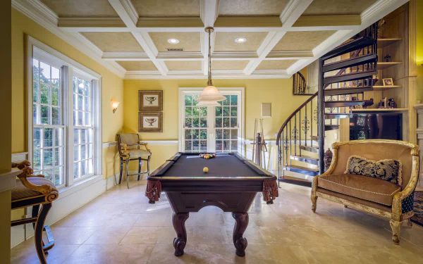 HD wallpaper of a bright interior lounge featuring a pool table, large windows, spiral staircase, elegant seating, and classic architectural details in a stylish room.
