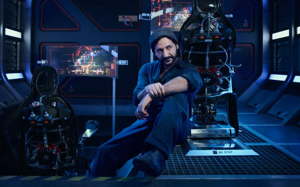 Cas Anvar as Alex Kamal from the TV show The Expanse in a futuristic, high-tech spaceship setting, featured in an HD PC desktop wallpaper.