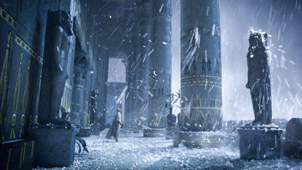 HD desktop wallpaper featuring a dramatic scene from the movie Exodus: Gods and Kings, with towering ancient statues and columns amid a snowy, stormy atmosphere.