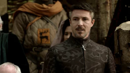HD desktop wallpaper featuring Aidan Gillen as Petyr Baelish from the TV show Game of Thrones, set in a medieval outdoor scene.