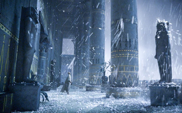 HD desktop wallpaper featuring a dramatic scene from the movie Exodus: Gods and Kings, with towering ancient statues and columns amid a snowy, stormy atmosphere.
