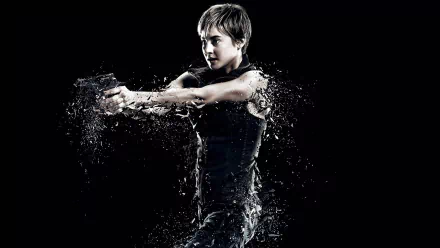 HD PC desktop wallpaper: a character from the movie Insurgent aims a handgun as water splashes around them against a stark black background.