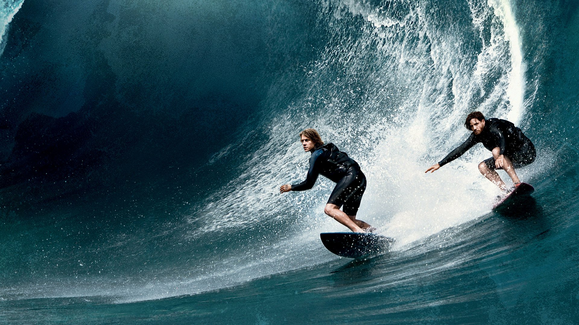 4K desktop wallpaper: Johnny Utah and Bodhi from Point Break (2015) carve a massive barrel together, cinematic surf action and spray.