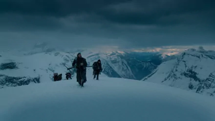 HD PC desktop wallpaper featuring a snowy mountain scene from the movie The Revenant, showing characters trekking through a harsh winter landscape.