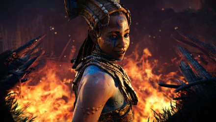 HD PC desktop wallpaper featuring a character from the video game Far Cry Primal, standing amidst flames with an intense, tribal atmosphere.