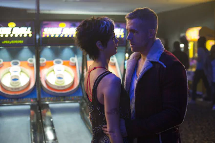 Morena Baccarin and Ryan Reynolds share an intimate moment in a scene from the movie *Deadpool*, set against a vibrant arcade background.