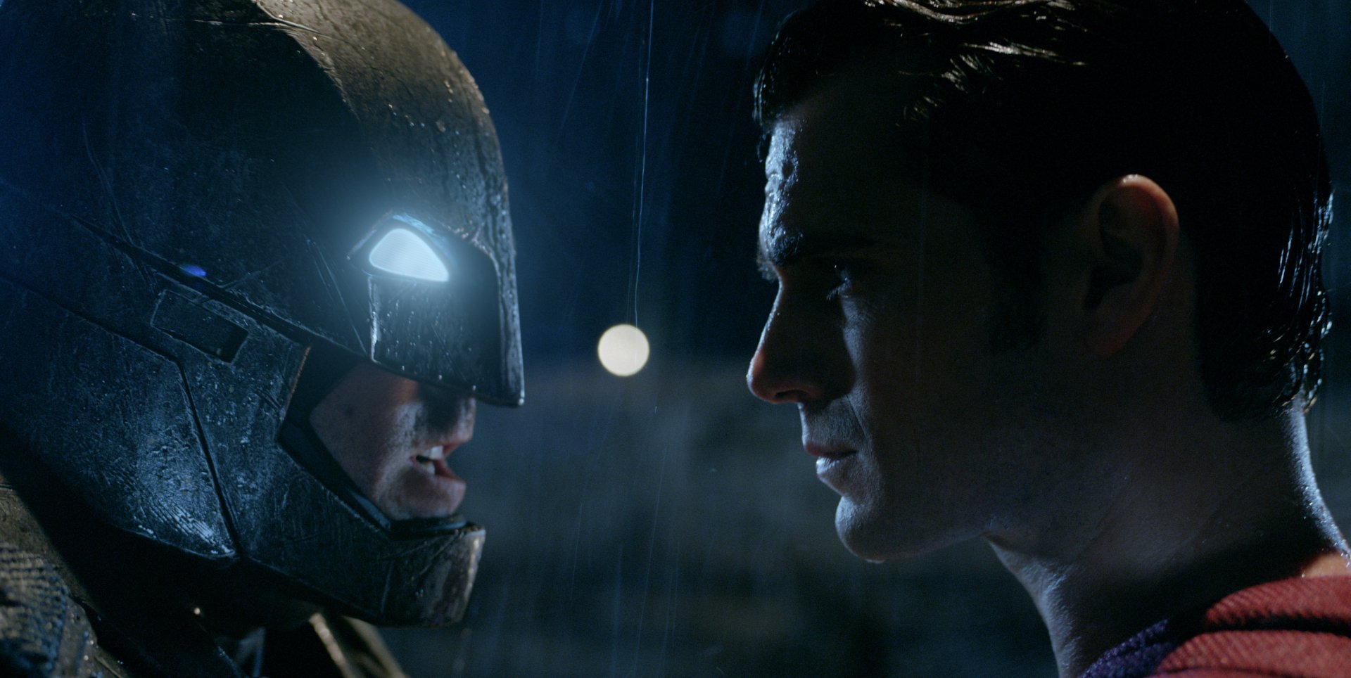 A HD wallpaper featuring Batman and Superman face-to-face in a tense moment from the movie Batman V Superman: Dawn of Justice, with Henry Cavill as Superman.