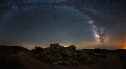 Nighttime road in Italy beneath a vivid Milky Way arc, blending sci-fi atmosphere with natural beauty in this HD PC desktop wallpaper.