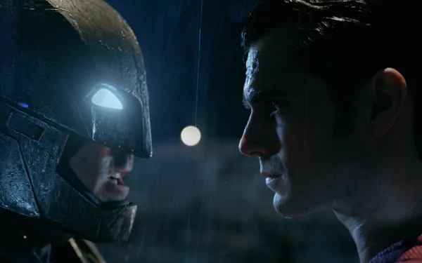 A HD wallpaper featuring Batman and Superman face-to-face in a tense moment from the movie Batman V Superman: Dawn of Justice, with Henry Cavill as Superman.
