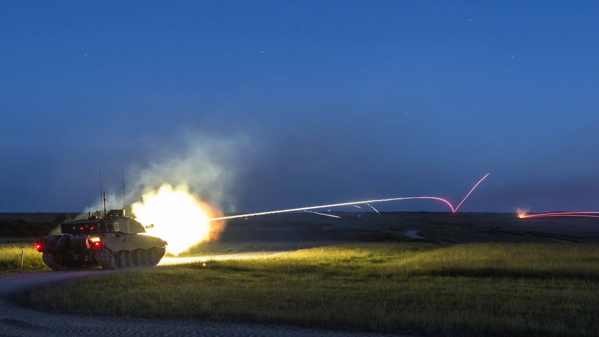 Challenger 2 tank firing at night, captured in a dynamic military HD desktop wallpaper and background.