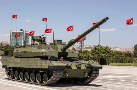 HD desktop wallpaper showcasing an Altay military tank on a paved open area with multiple Turkish flags in the background under a clear sky.